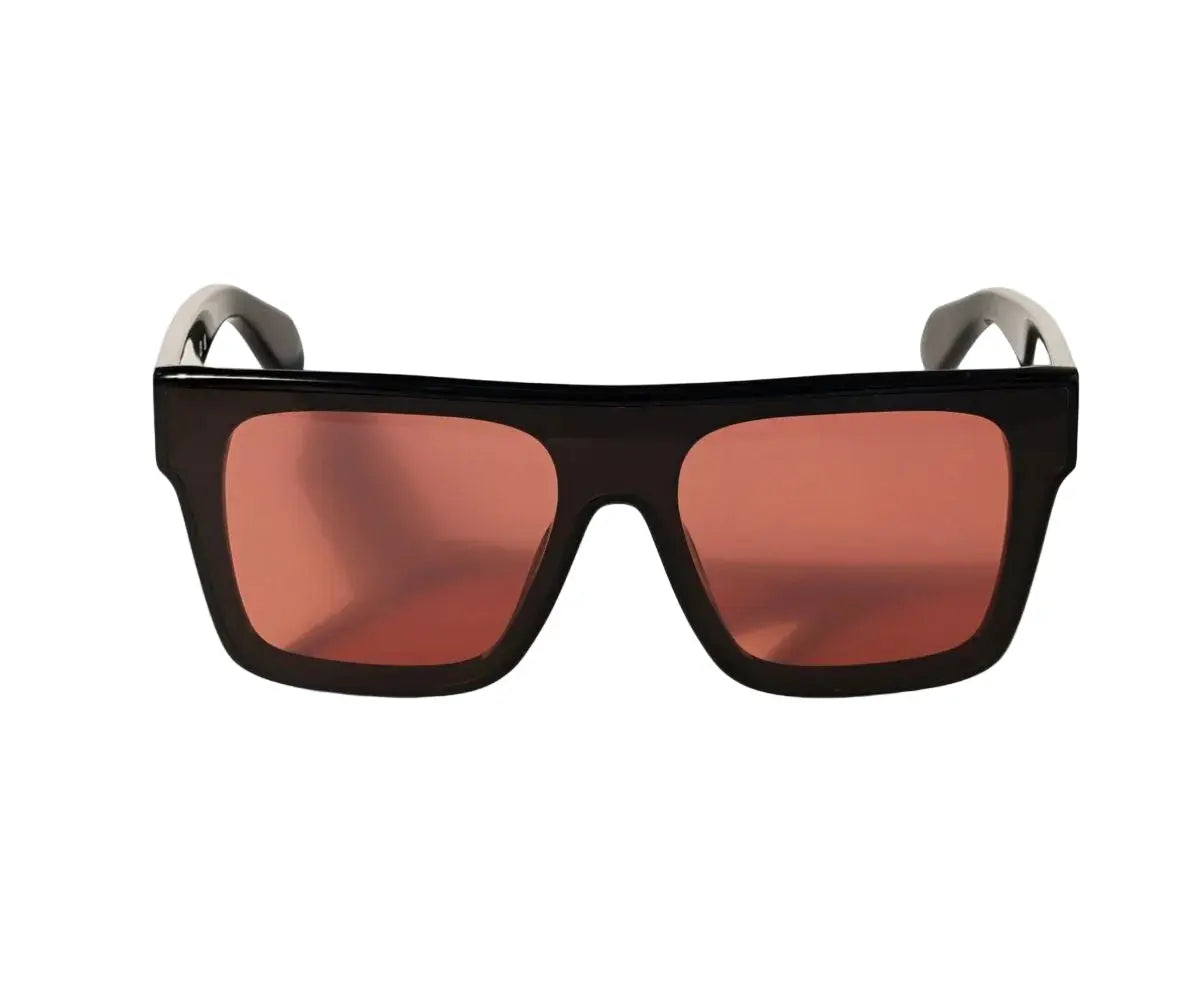 Sunglasses with black frame and red-tinted lenses on a white background