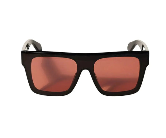 Sunglasses with black frame and red-tinted lenses on a white background