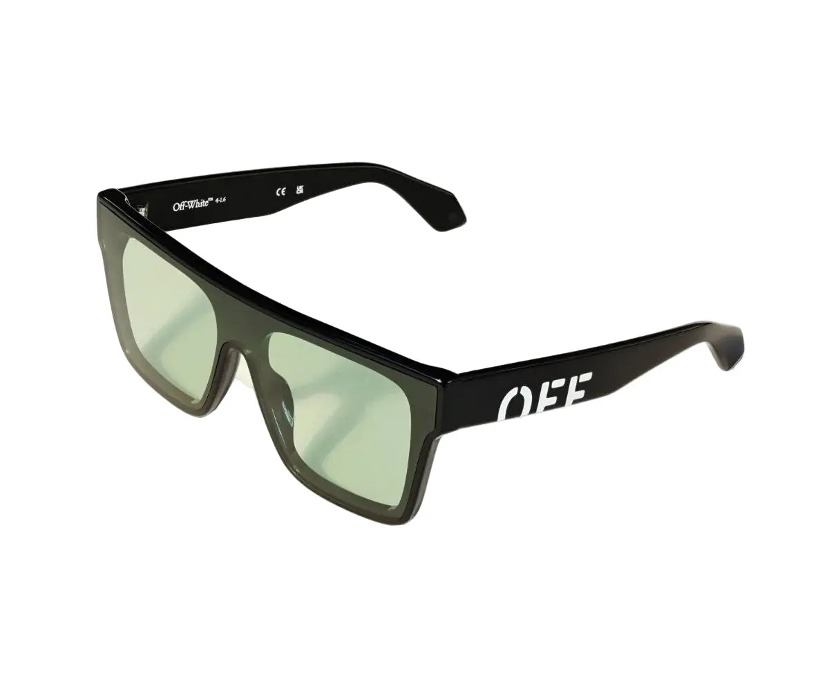 Black sunglasses with green lenses on a white background