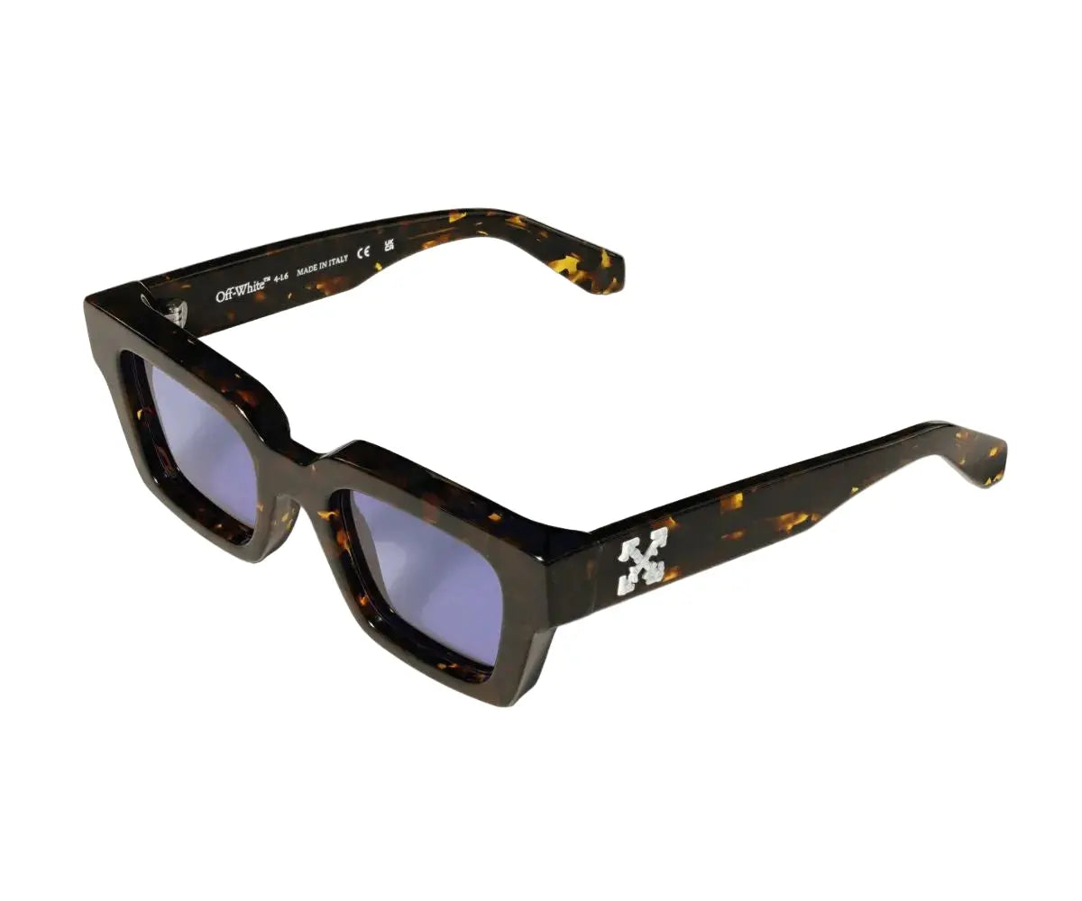 Sunglasses with tortoiseshell frame and blue lenses on a white background