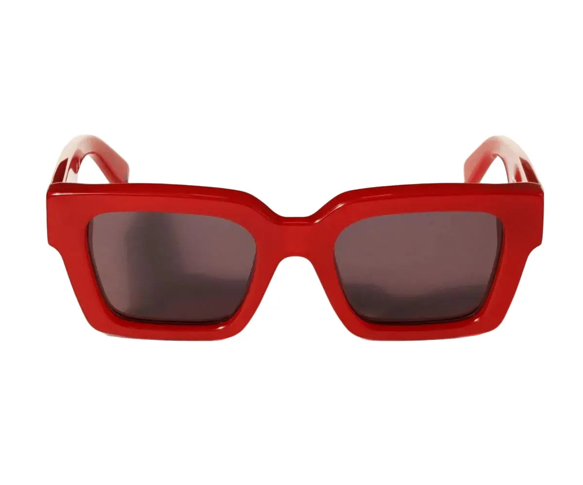 Red sunglasses with dark lenses on a white background
