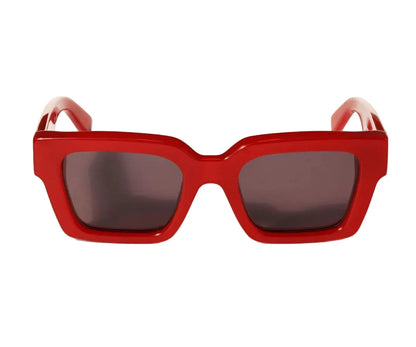 Red sunglasses with dark lenses on a white background