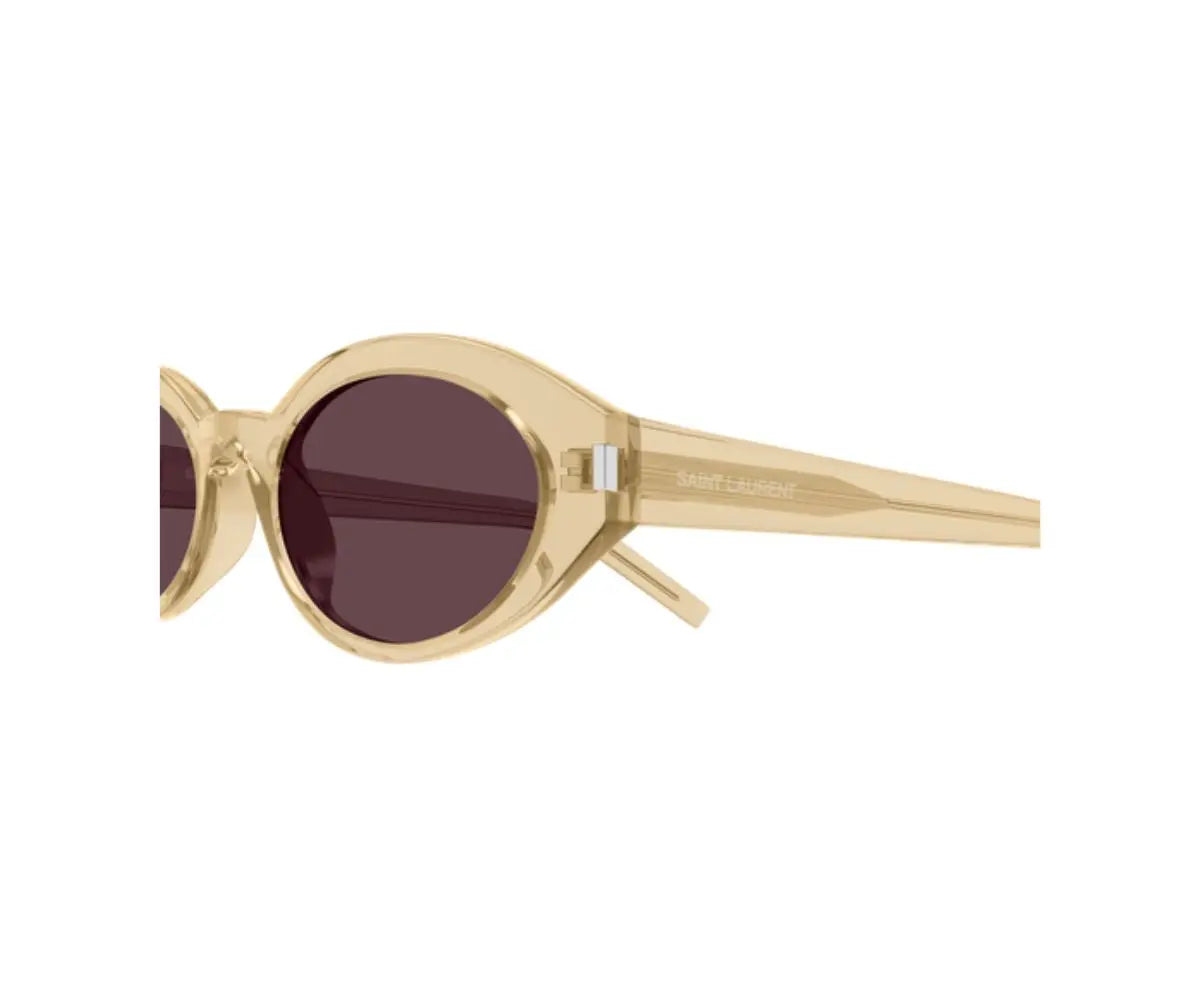 Gold-framed sunglasses with dark lenses on a white background