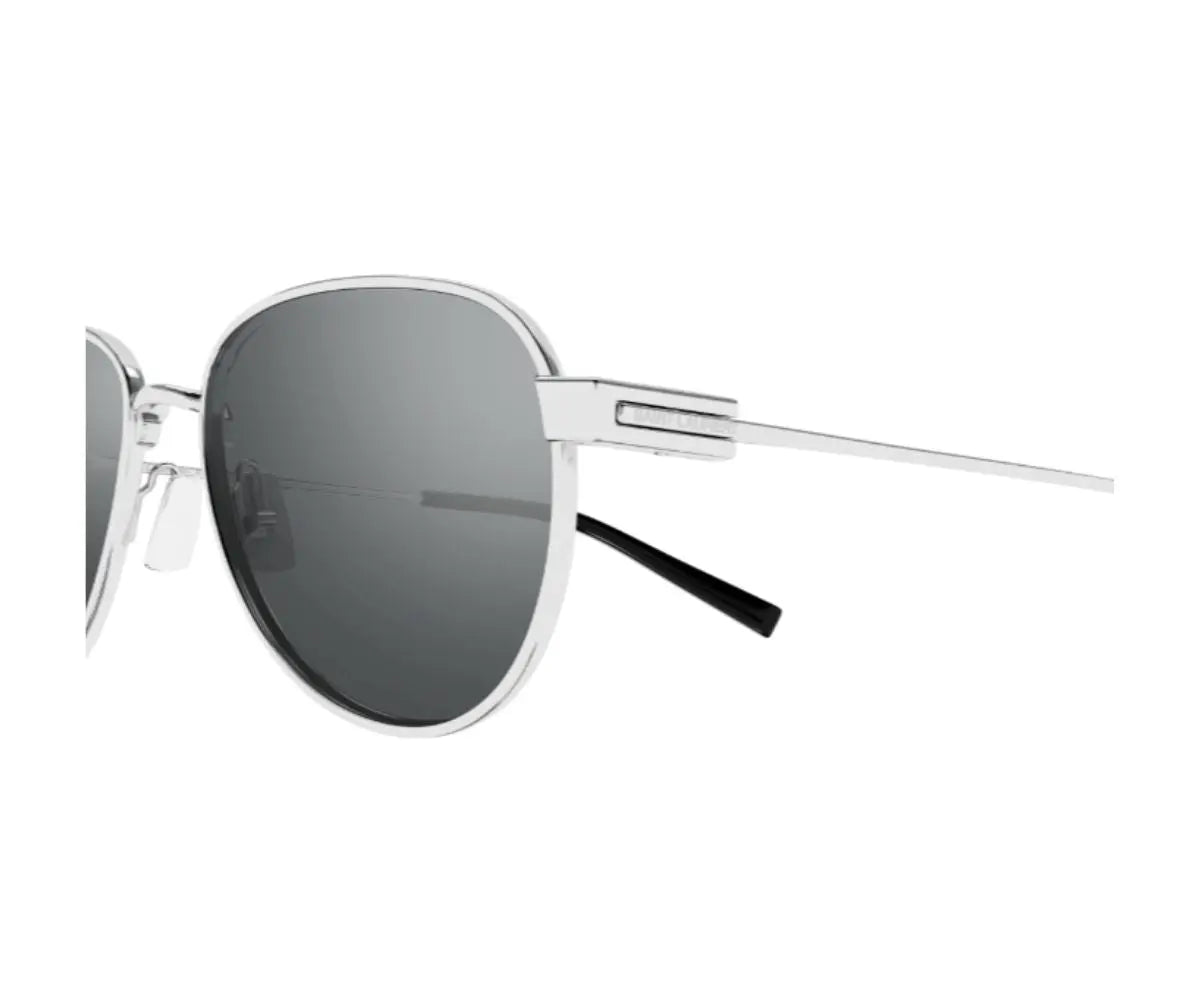 Sunglasses with silver frame and dark lenses on a white background