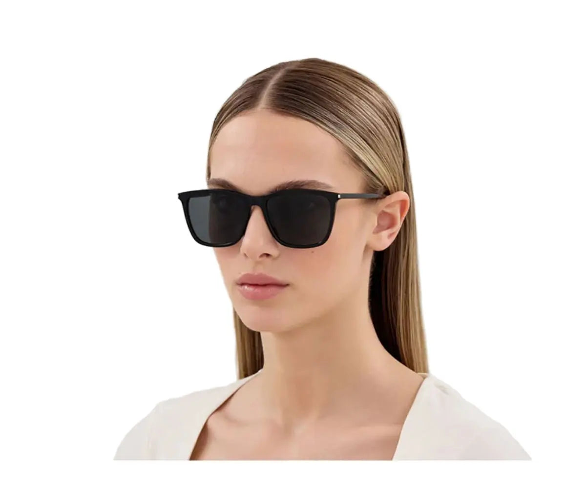 Woman wearing black sunglasses on a white background