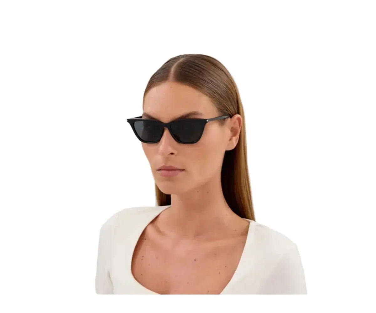 Woman wearing black sunglasses on a white background
