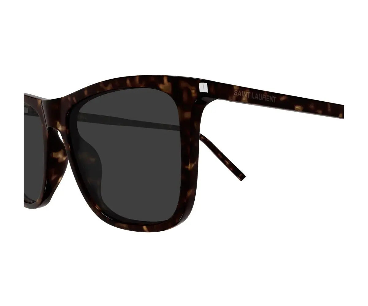 Sunglasses with tortoiseshell frame and dark lenses on a white background
