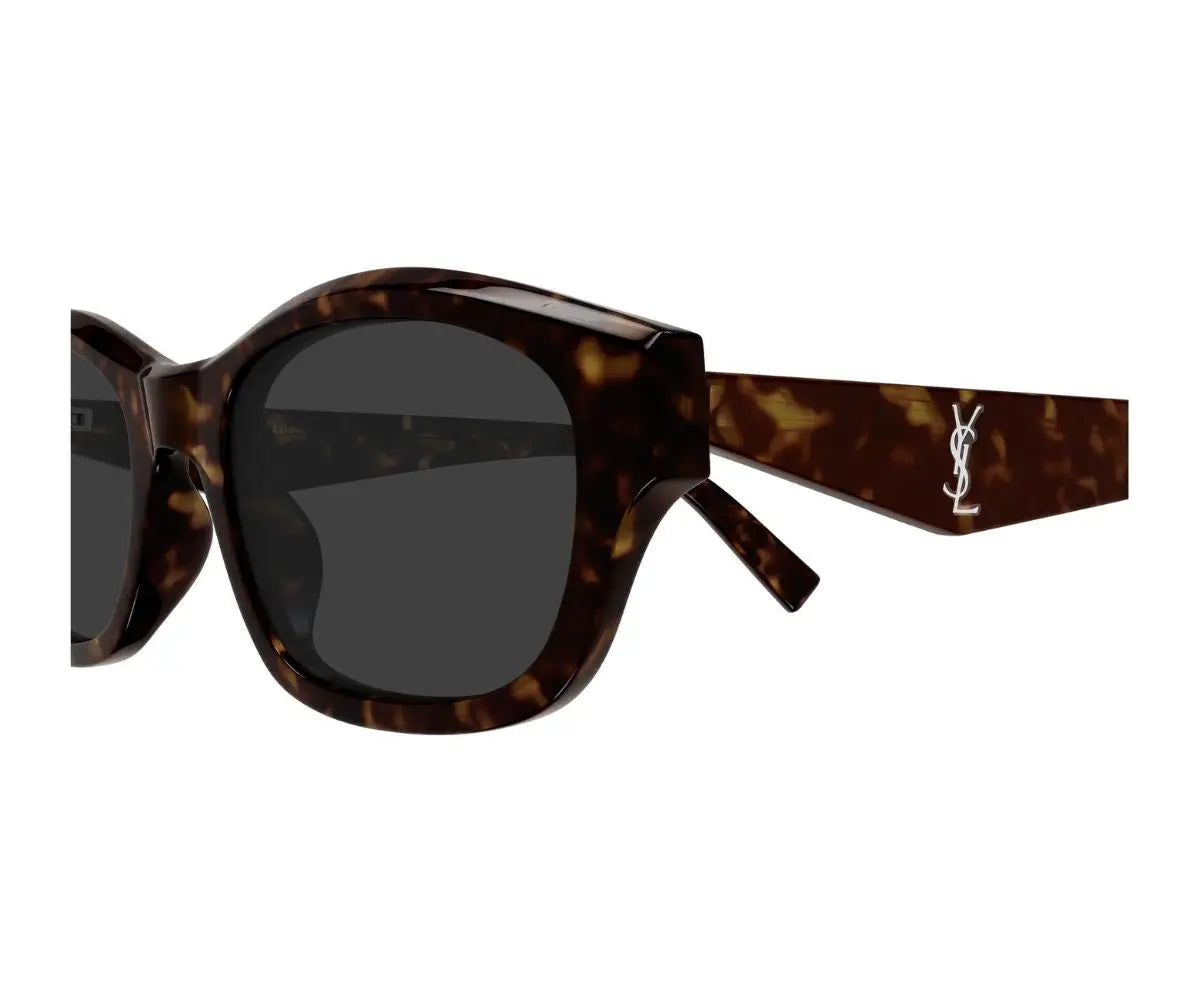 Sunglasses with tortoiseshell frame and dark lenses on a white background