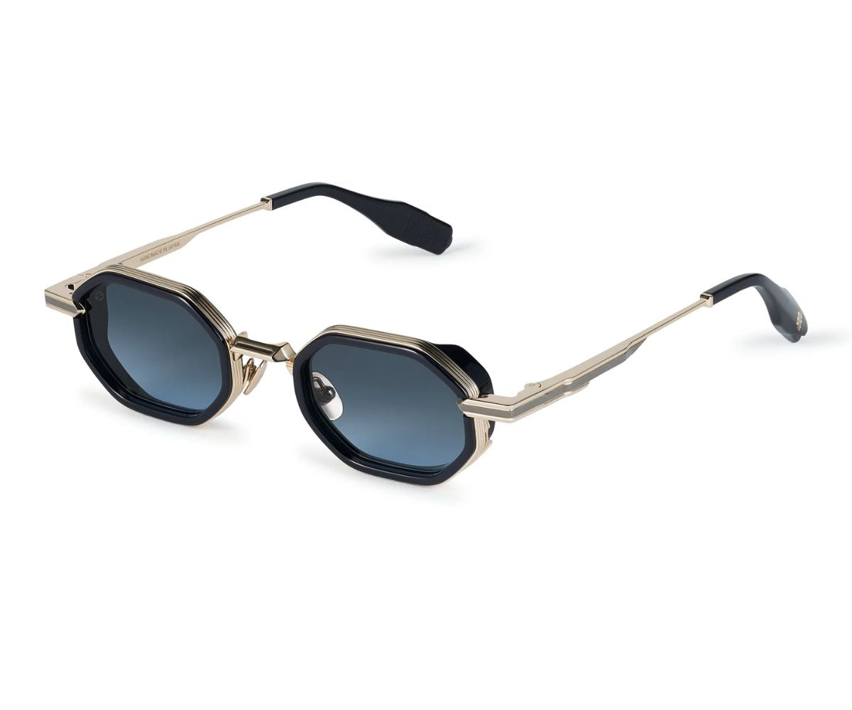 Sunglasses with gold frame and black lenses on a white background