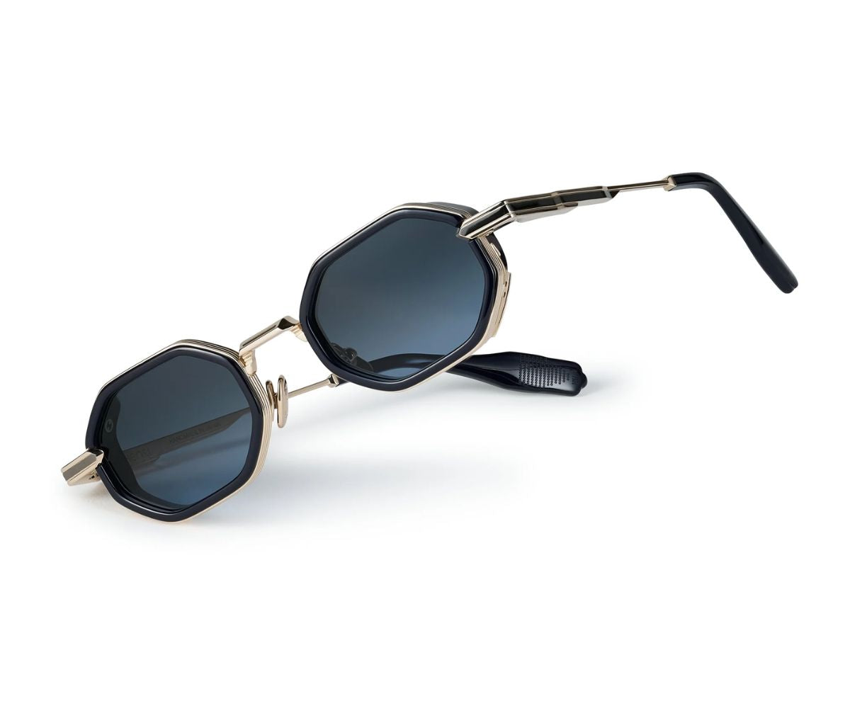 Sunglasses with gold frame and dark lenses on a white background