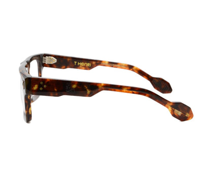 Tortoiseshell glasses with 'THOM' branding on a white background