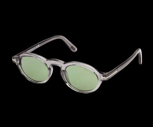 Sunglasses with green lenses and clear frame on a white background