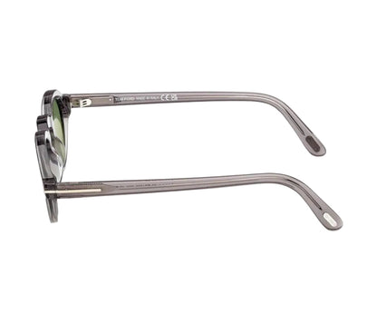 Sunglasses with a gray frame and green lenses on a white background