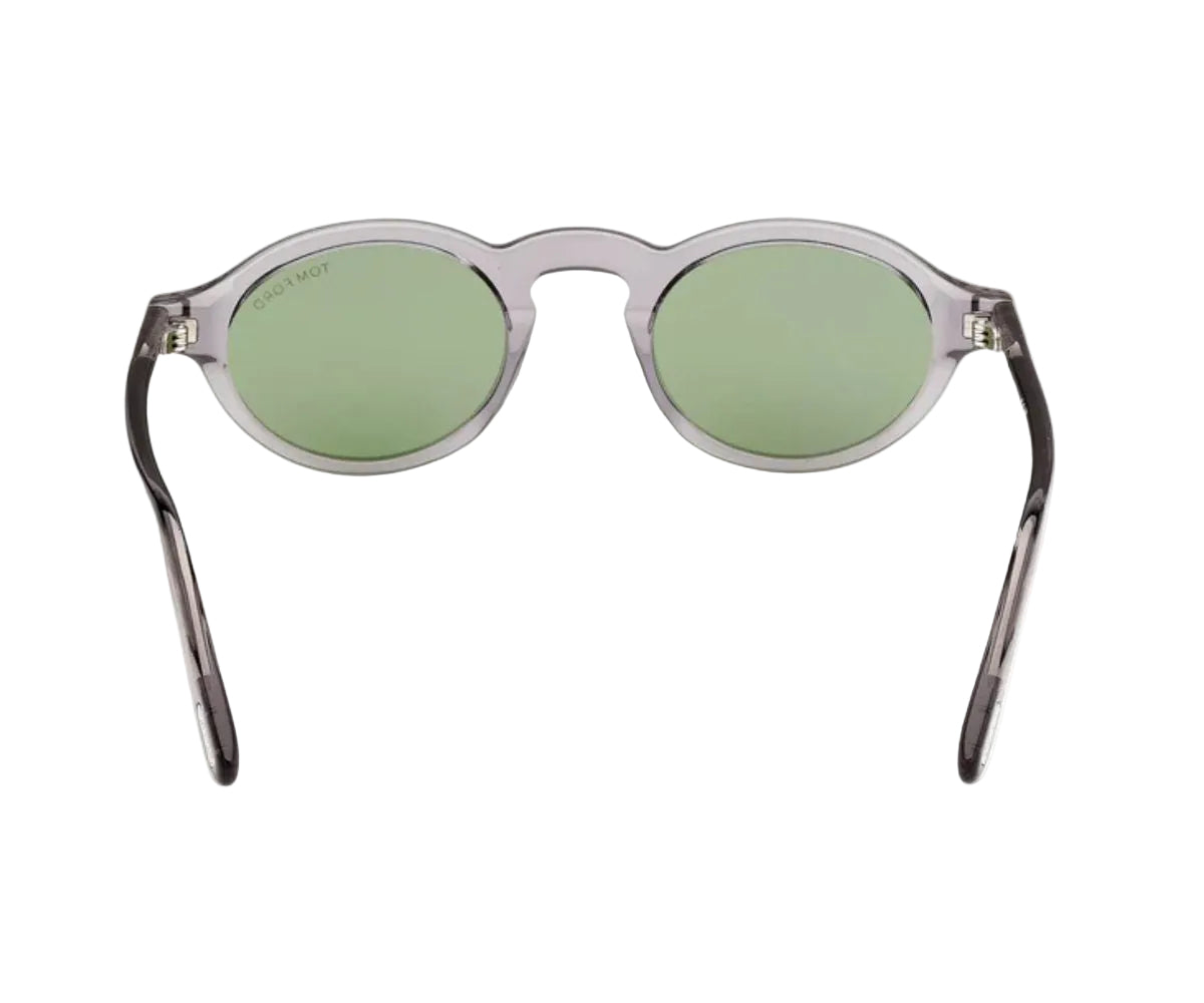 Sunglasses with green lenses and transparent frame on a white background