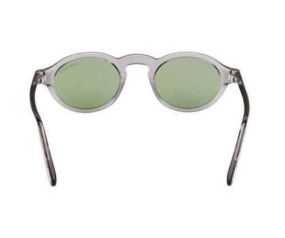 Sunglasses with green lenses and transparent frame on a white background