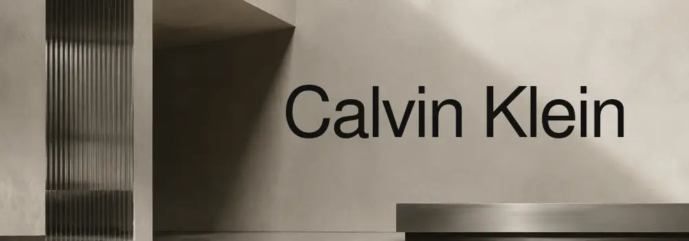 Calvin Klein eyewear collection banner with premium charcoal and warm concrete architectural background