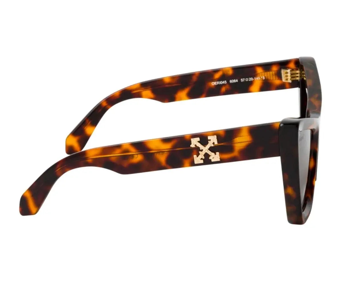 Sunglasses with tortoiseshell frame and gold logo on a white background