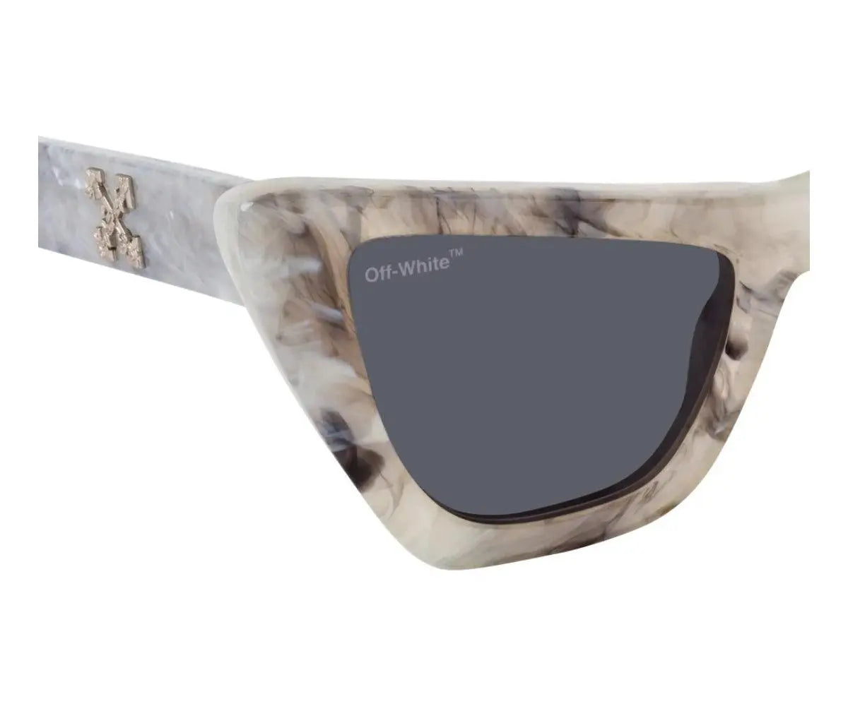 Sunglasses with a marbled frame and dark lens on a white background